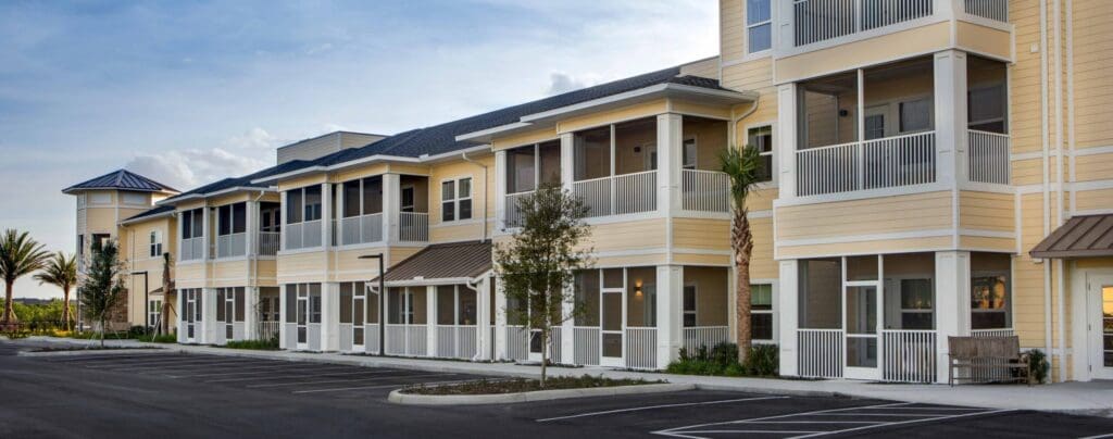 The Summit of Winter Garden building with beige walls and a few palm trees in front of it.